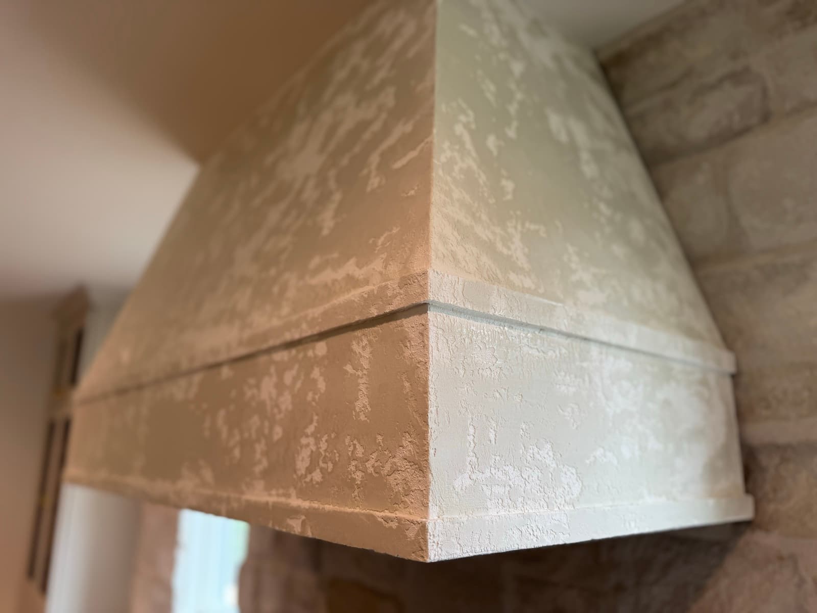Hand-textured plaster range hood